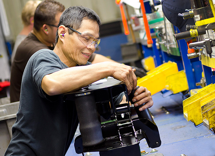 Man assembling a Cabmate unit on an assembly line