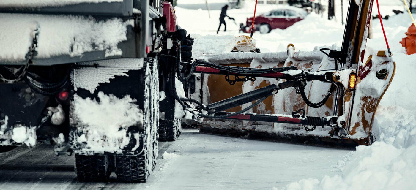 Snow plow truck plowing snow off the road