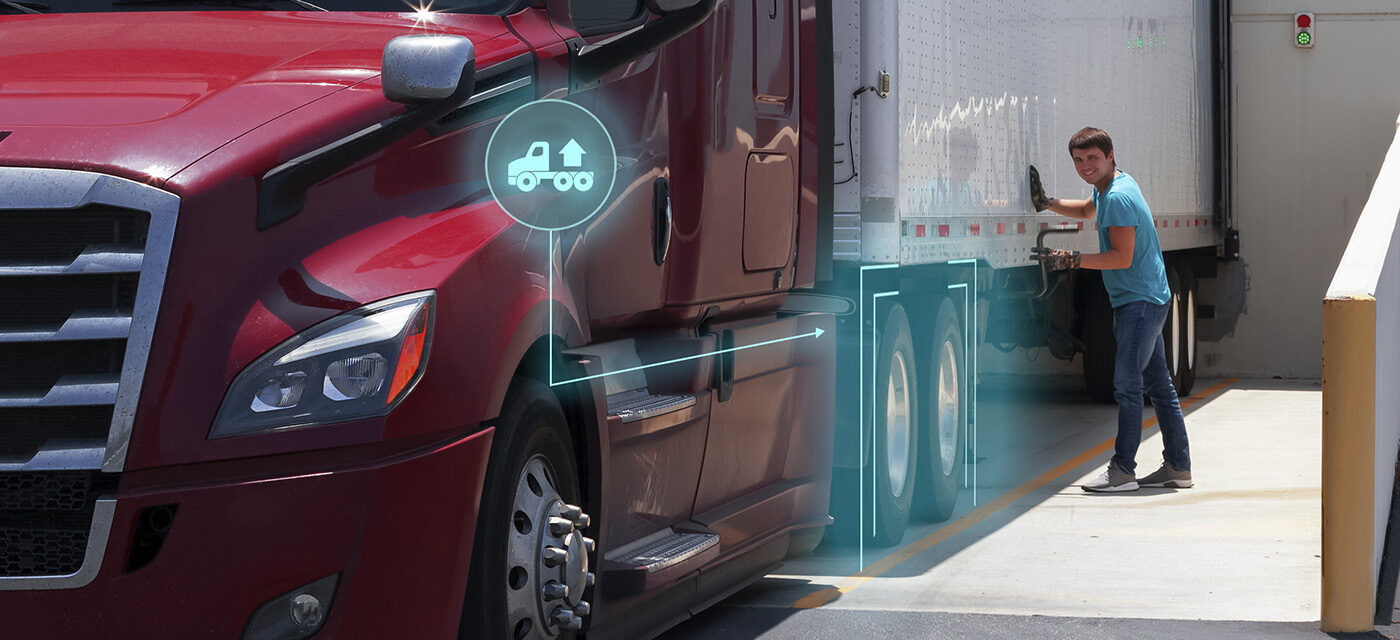 Man smiling as he cranks the landing gear of a trailer connected to a tractor equipped with SmartValve