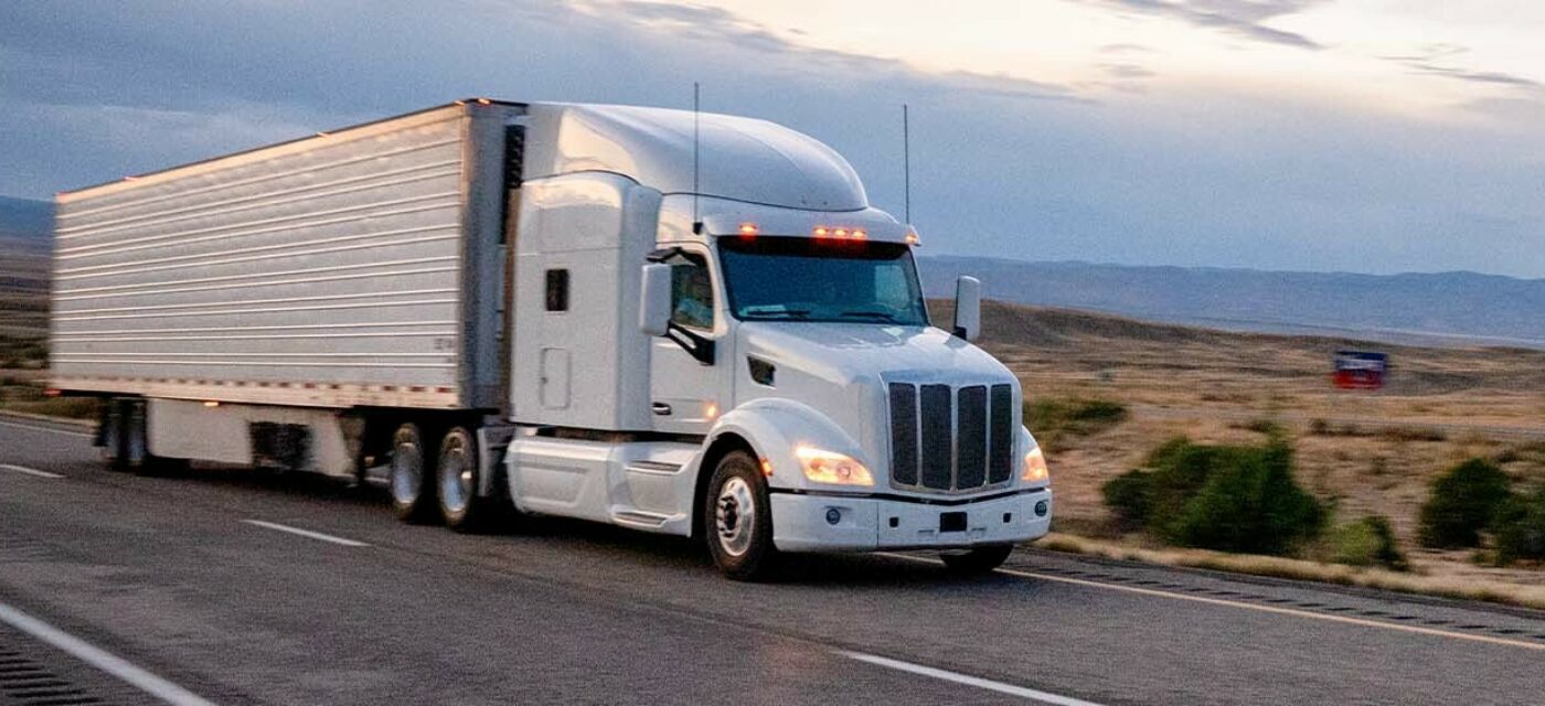 White truck and trailer on highway