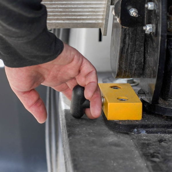 A hand pulling the quick release latch to release the ramp from its outside position.