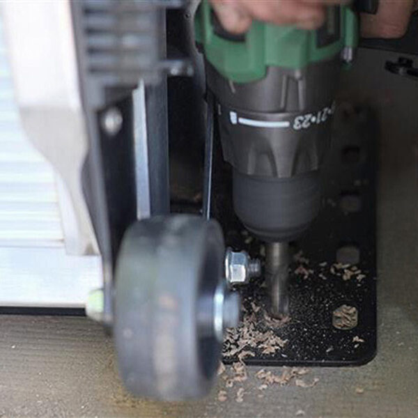 Drilling a hole into the floor of a cargo van to install a LB20 ramp.