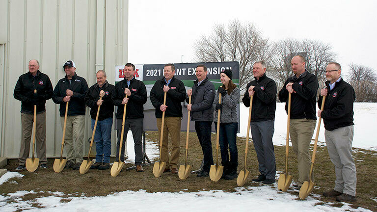 The Link leadership team and Sioux Center, IA's mayor standing with gold shovels in front of the future location of Link's plant 4