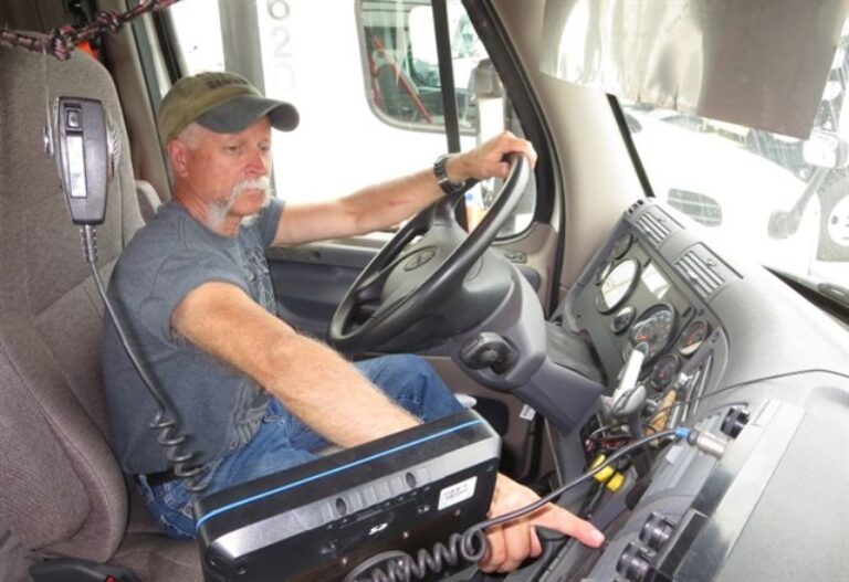 Man pressing button in semi cab
