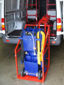 CL400 machine lift pivoted outside cargo van with cleaning equipment aboard.