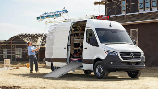 A Link Side Door Ramp extending out of a Mercedes Benz Sprinter Cargo Van.