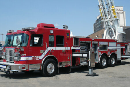 A fire truck with its ladder extended, equipped with the Air Link tandem drive axle suspension