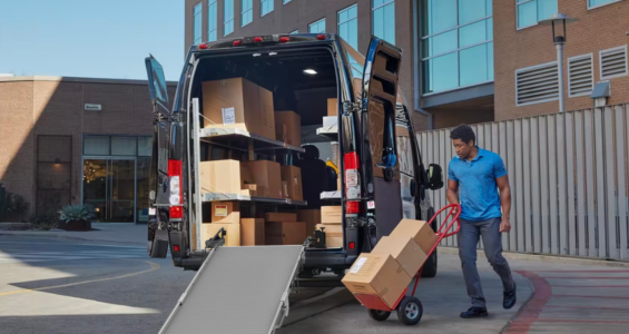 A delivery driver loading a Ram Promaster using a Link Swivel Ramp