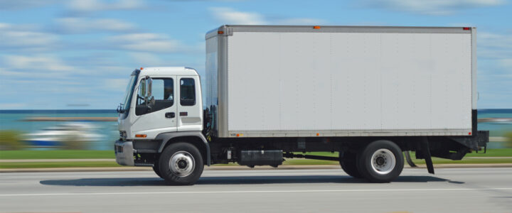A class 6 truck driving on a highway