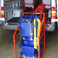 CL400 machine lift pivoted outside cargo van with cleaning equipment aboard.