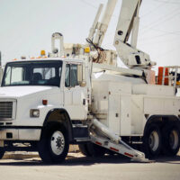 A crane truck with its crane extended equipped with an Air Link Tandem Drive Suspension