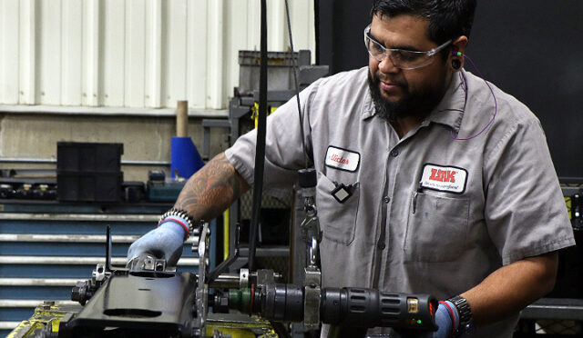 Man assembling a Cabmate unit with a drill