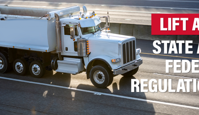 Dump Truck on highway with "Lift Axle - State and Federal Regulations"