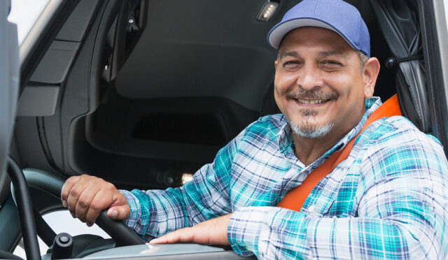 Driver leaning out window smiling