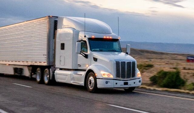White truck and trailer on highway