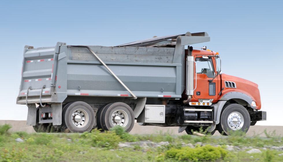 A dump truck on gravel roads
