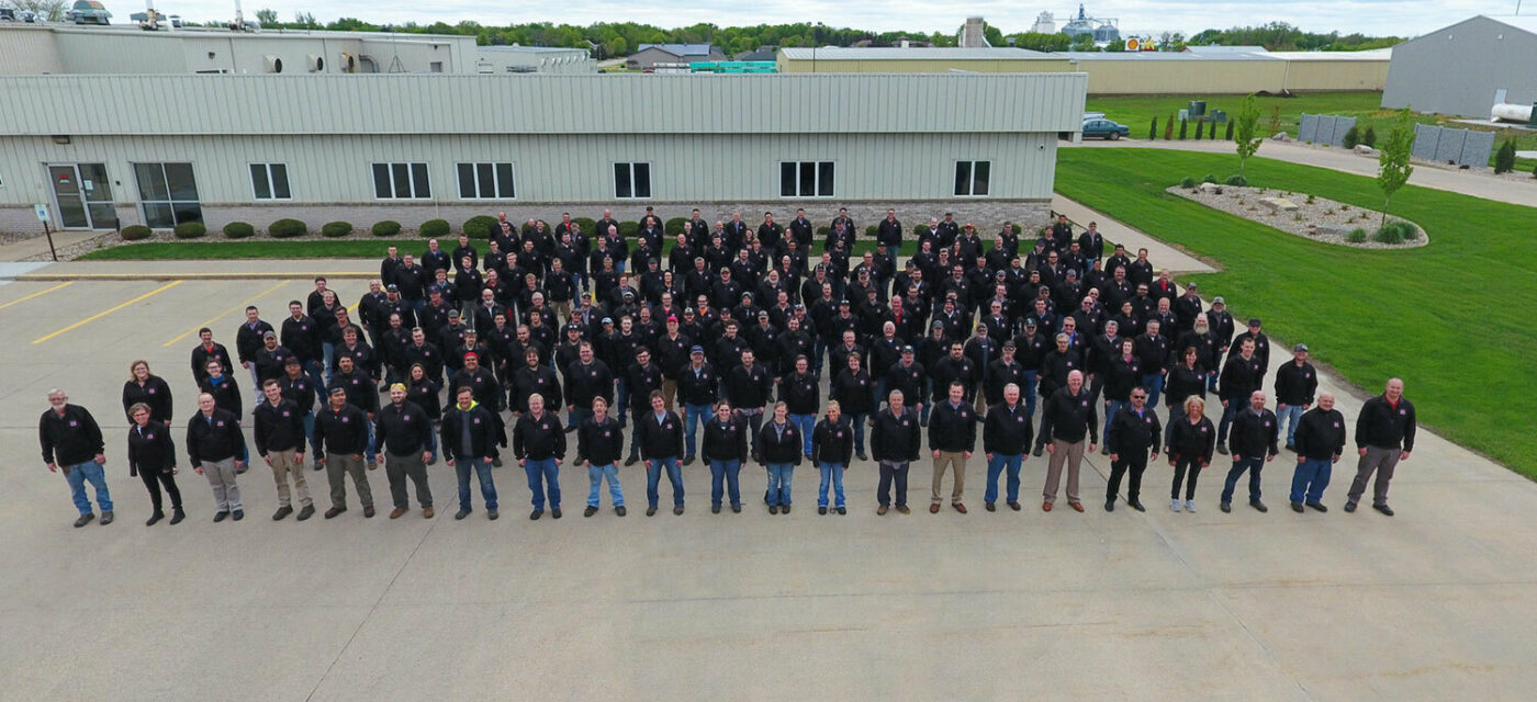An Aerial photo of the Link employees outside of the Sioux Center, IA Link Mfg. Administrative Office in 2 Millionth Cabmate clothing