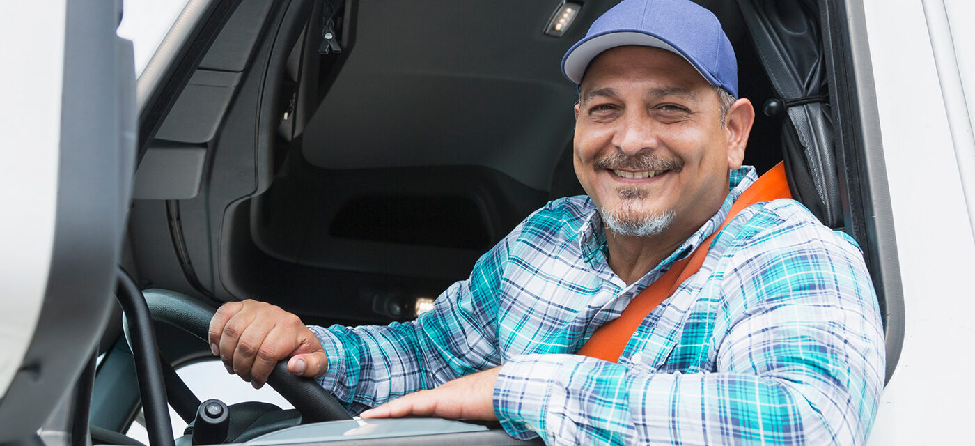 Driver leaning out window smiling