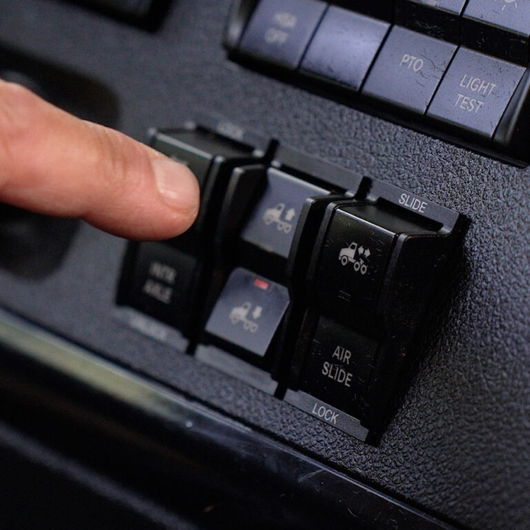A finger having just pressed the SmartValve Factory-Installed dump switch.