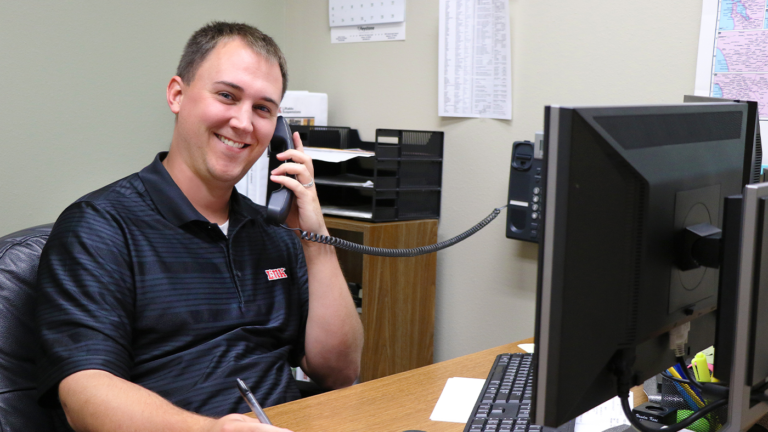 Man answering phone with a smile
