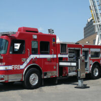 A fire truck with its ladder extended, equipped with the Air Link tandem drive axle suspension