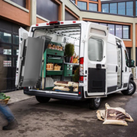 A Link Swivel Ramp swiveled 90 degrees outside of a Ram Promaster delivering produce.