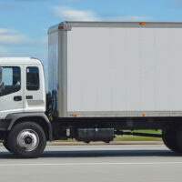 A class 6 truck driving on a highway